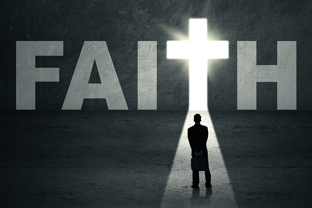 Man standing in the path that leads to the cross with the light coming through the word Faith